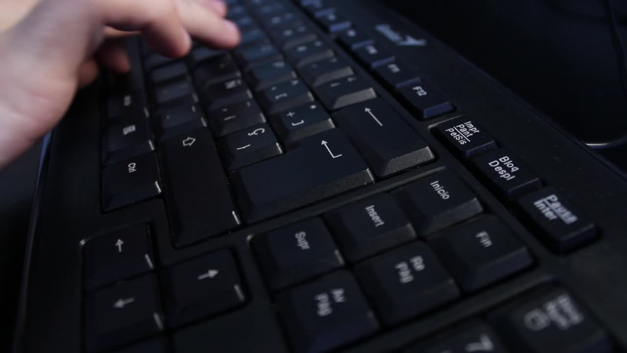 Close-up of Hand Typing on a Black Computer Keyboard