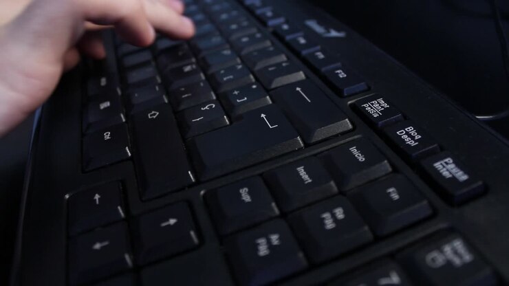Close-up of Hand Typing on a Black Computer Keyboard