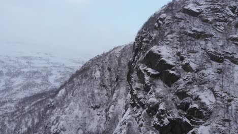 Steep-mountain-ridge-in-inhospitable-landscape-of-Scandes-mountain-range---Aerial-Slide-parallax