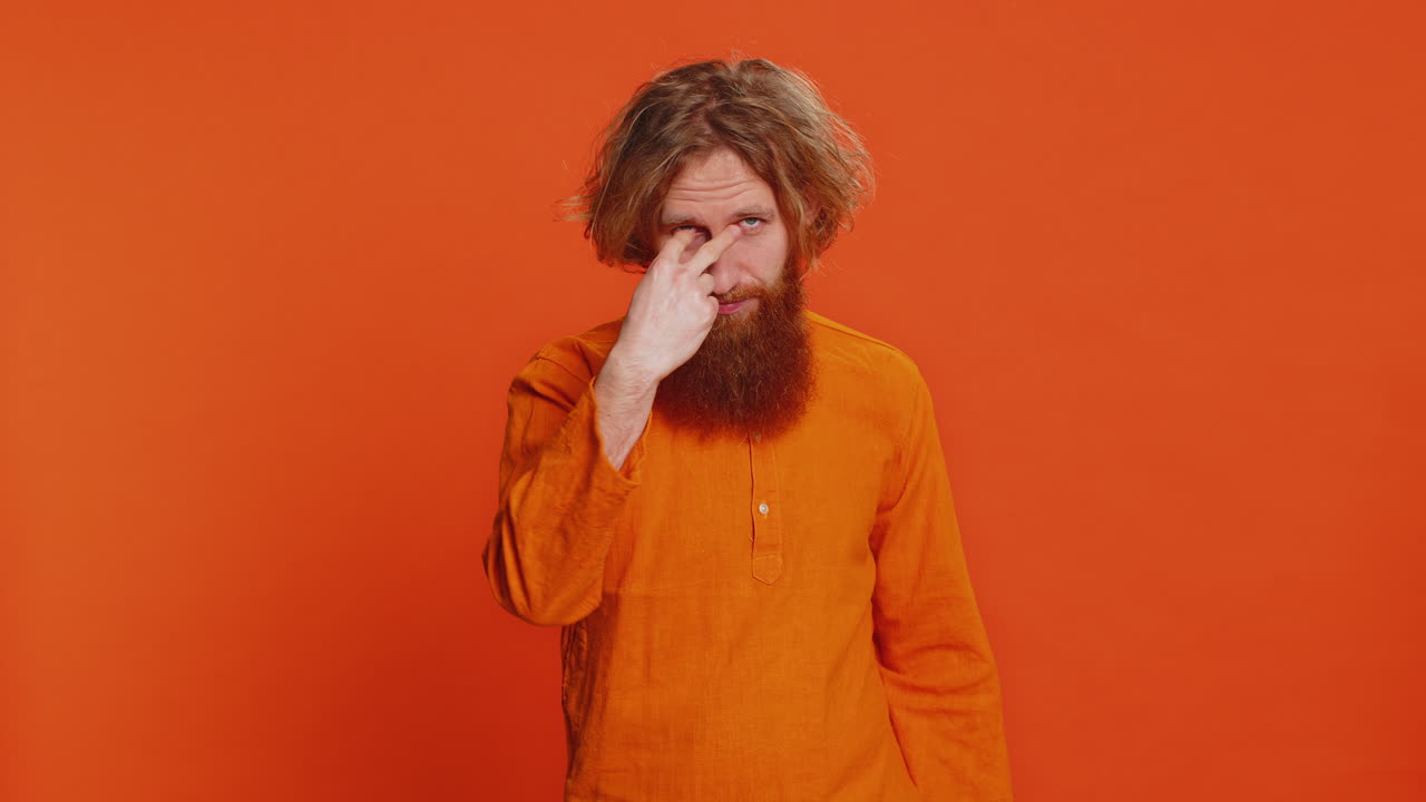 Man pointing at his eyes and camera show I am watching you gesture spying watching on someone