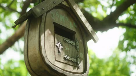 old vintage bird feeder house on a green tree