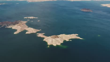 a high-flying drone shot over lake mead, a massive reservoir formed by the hoover dam on the colorado river, that lies on the border of arizona and nevada, just east of las vegas