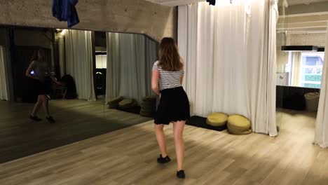 slow motion talented teenage female dancer dancing in front of a mirror