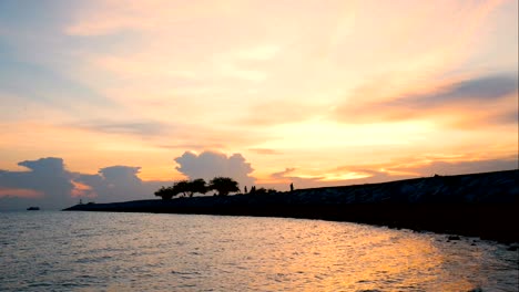 time lapse of silhouette happy people and family walking on the bridge over the sea along edge of sunset beach. spend time together with relax happy life outdoor activity on tropical summer vacations