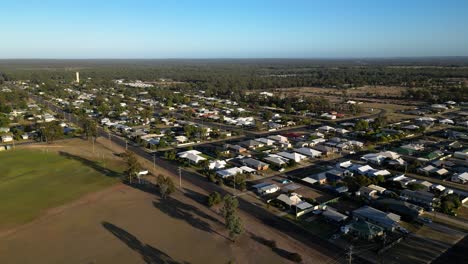 reversing aerial views over residential housing in the small town of miles queensland.