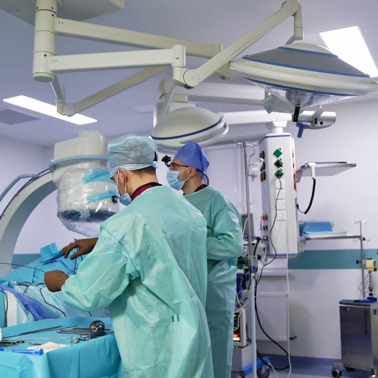 Harmonious work of surgical team during operation. Chief surgeon assisted by the male doctor quickly changes instruments during operation