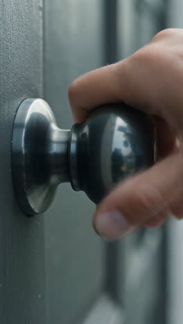 Hand turning a doorknob