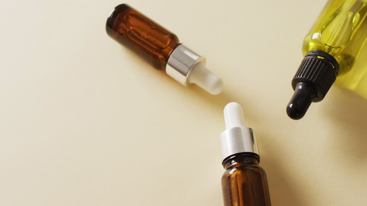 Close up of dropper serum bottles on white background with copy space