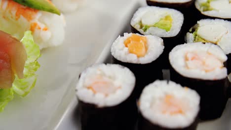 sushi on tray with chopsticks