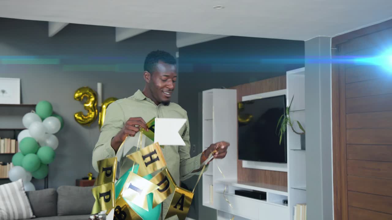 Man fixing gold banner and tweaking teal balloon at home, partner entering, prepping 30th birthday