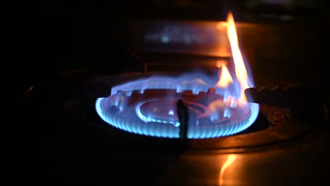 burn burner. gas is switching on, apearing blue flame gas stove video 4k