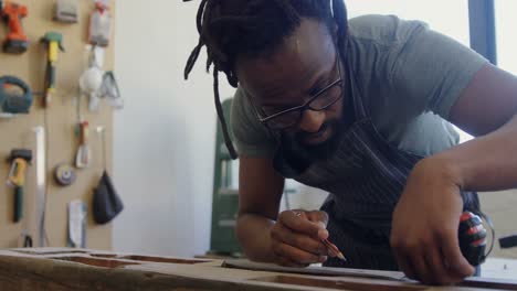 carpenter marking with pencil on wood 4k