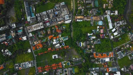 Cinematic-drone-footage-of-Berawa-beach-in-Canggu,-Bali-with-beautiful-landscape,-expensive-hotels-and-villas-through-calm-weather