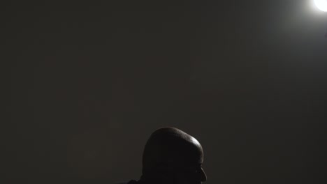 close up side view studio shot of male basketball player shooting ball at basket 6