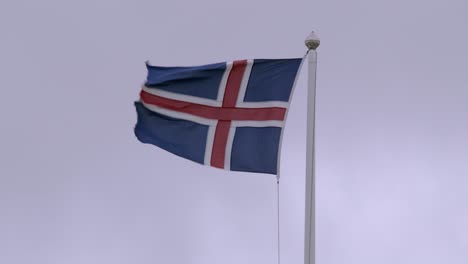 the icelandic flag waves on a cloudy day, symbolizing national pride and heritage
