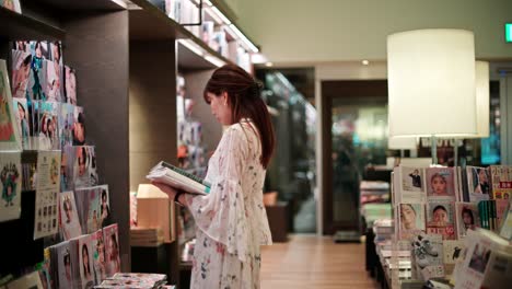 Woman Browsing Magazines in a Bookstore