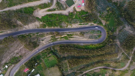 aerial view of a winding road through a green landscape