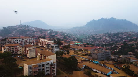 aerial view over apartment buildings in the suburbs of hazy yaounde, cameroon