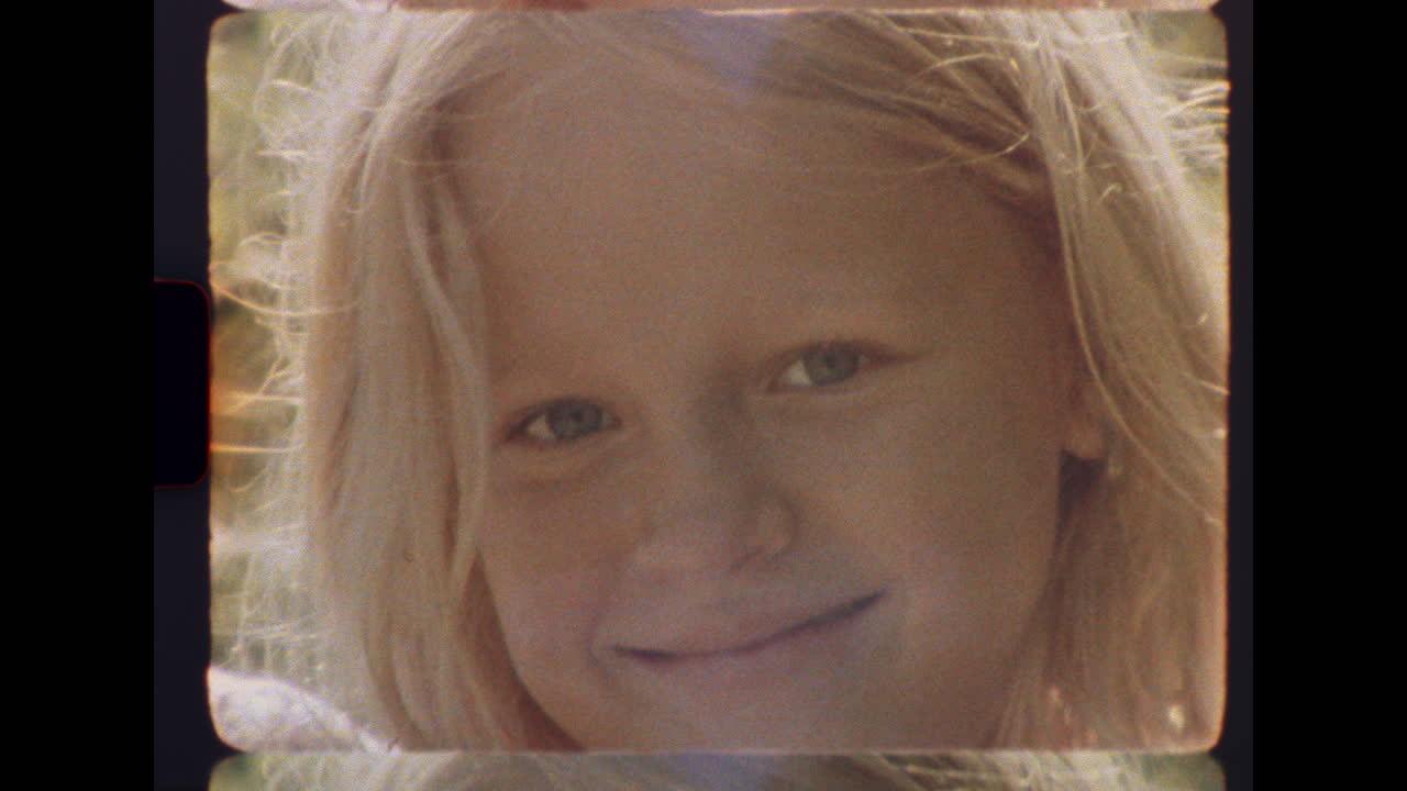 Little girl climbing wooden railing on sunny porch