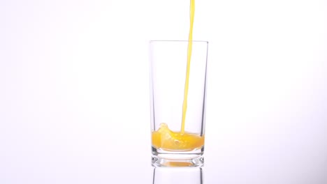orange juice pouring into a glass
