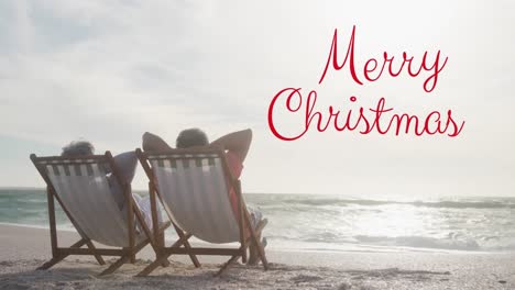 Animation-of-merry-christmas-text-over-senior-biracial-couple-at-beach