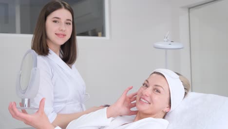 a beautiful woman is lying on a couch at a reception by a beautician. the doctor makes beauty injections to the lips. vertical video