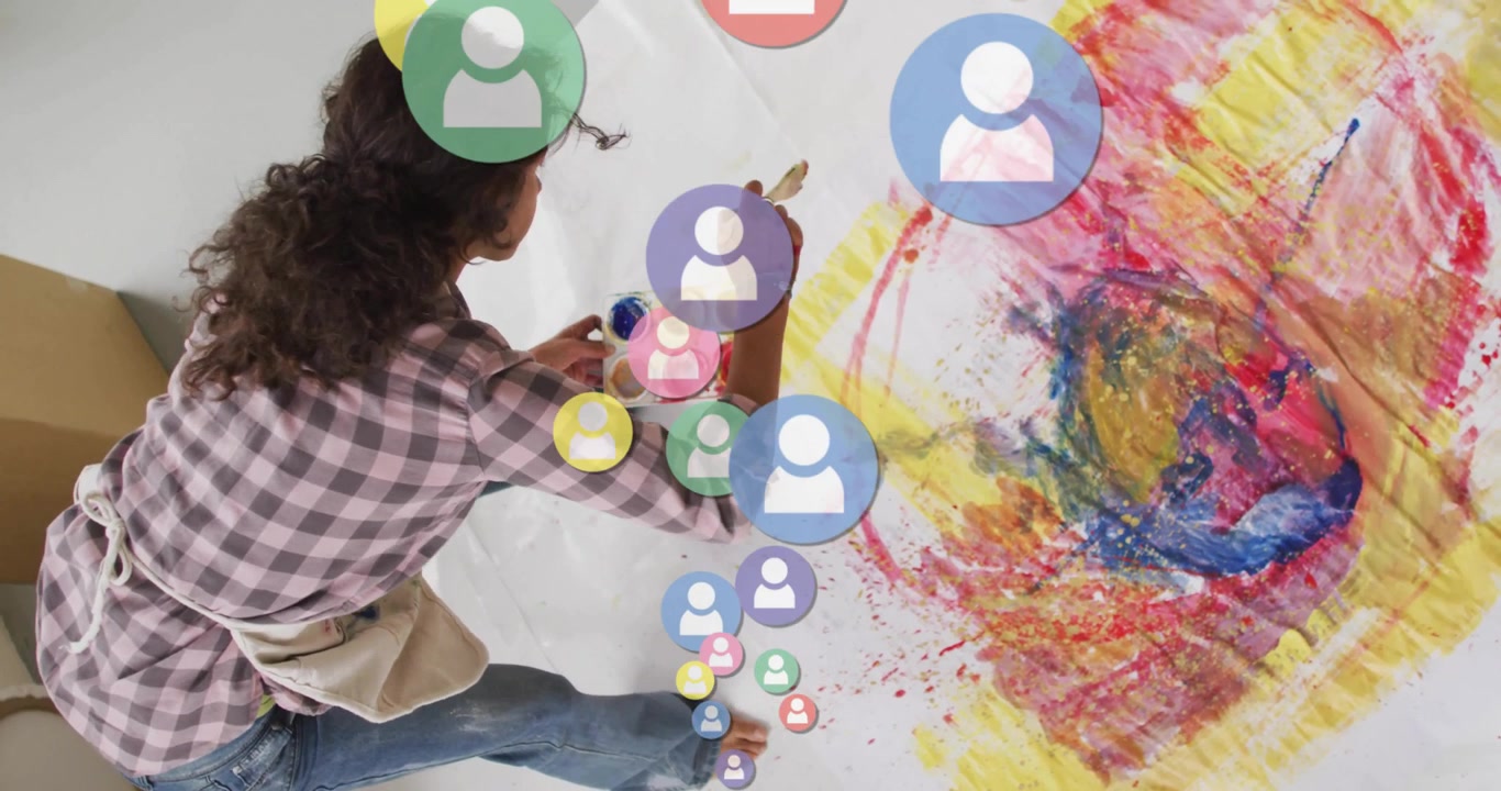 On user icons appearing, woman painting swirl brushing paint around icons for creative design