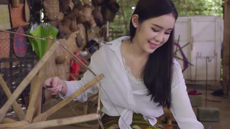 woman weaving traditional thai textiles