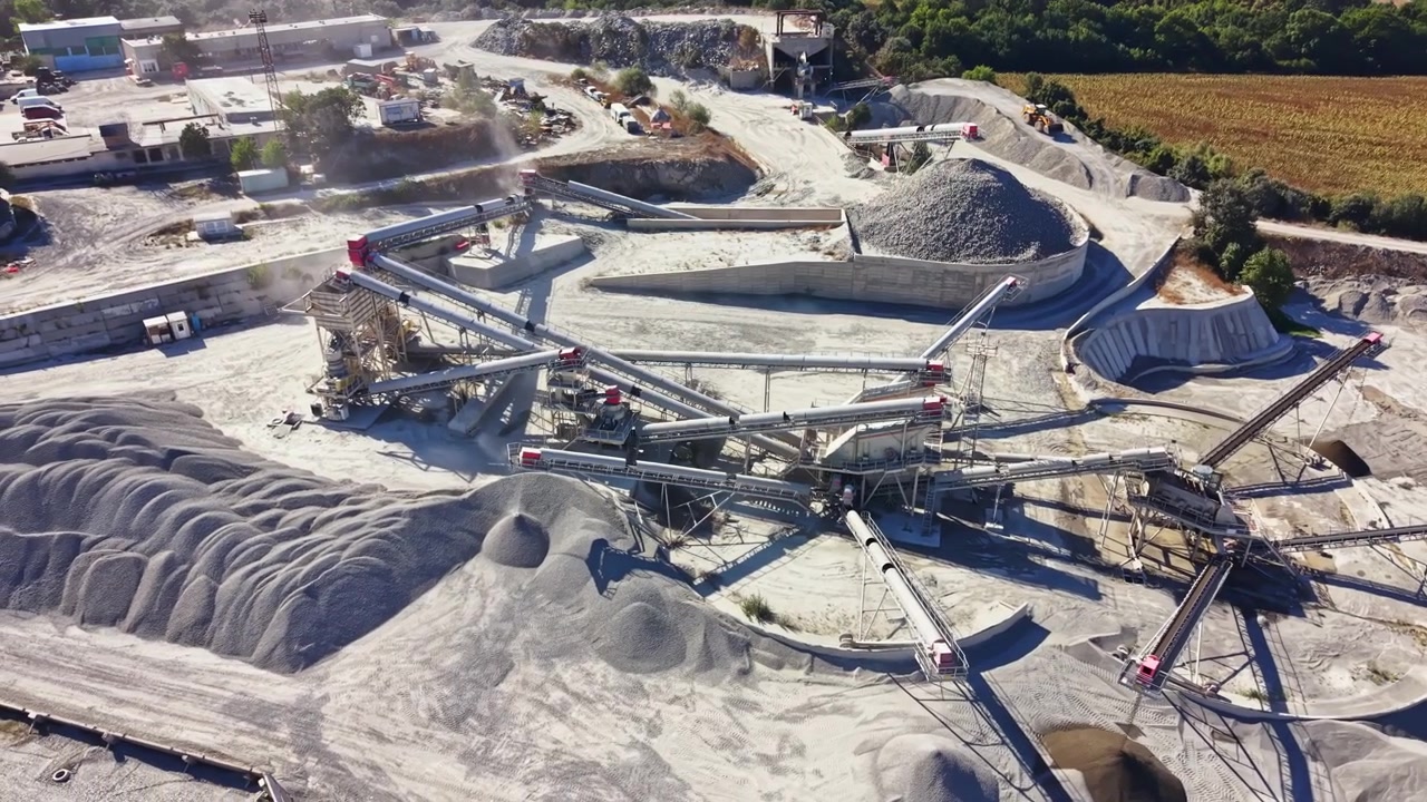 Granite quarry operations taking place during the day with machinery and raw materials visible