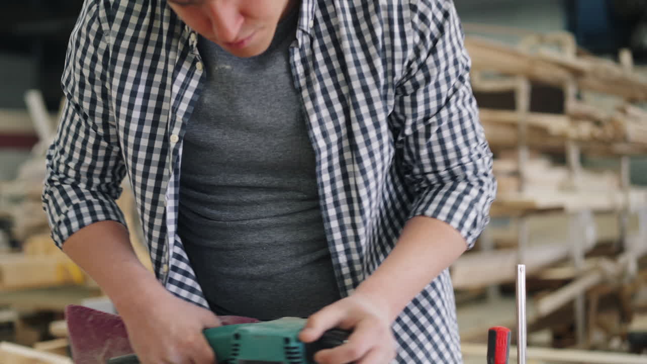 Woodworker Using a Planer in a Workshop