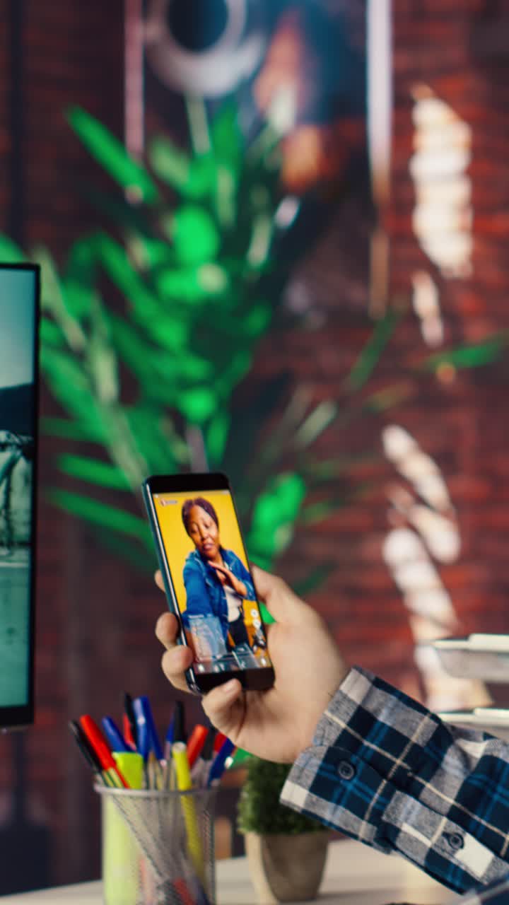 Vertical video Man at home having fun looking at social media reels done by content creators