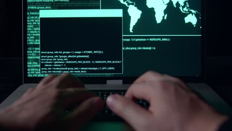 hands hacker using laptop computer hacking in the dark room
