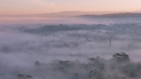 a foggy morning over the indonesian countryside