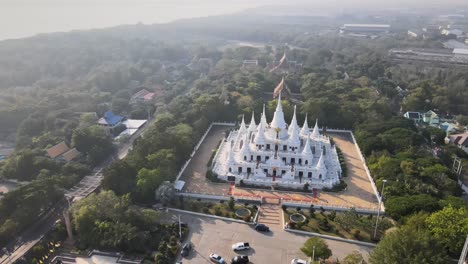 4k-Cinematic-pan-backward-from-Wat-Asokaram-temple-to-Sunset-reflection-on-the-river-in-Samut-Prakan,-Bangkok,-Thailand