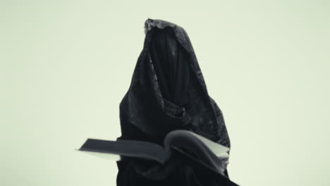 mysterious figure reading a book