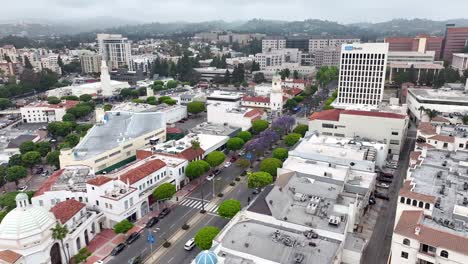 Downtown-Westwood-Village,-California-aerial-flyover-with-the-Jacaranda-trees-in-bloom