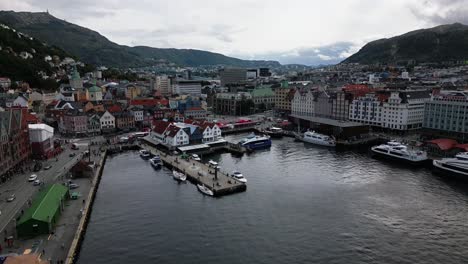 puerto en el centro de la ciudad, montañas con bosque en el fondo de la ciudad. bergen, noruega, europa, avión no tripulado
