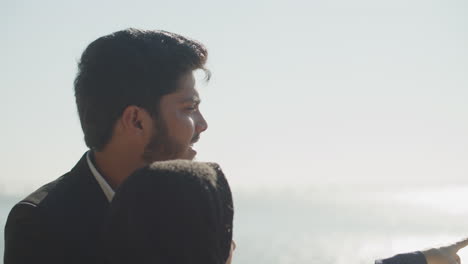 arabic couple from middle east standing next to bridge railing