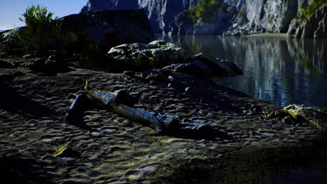 Tranquil lake view with rocky shoreline under bright blue sky