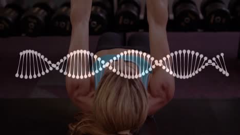 animation of dna strand spinning and data processing over strong woman exercising