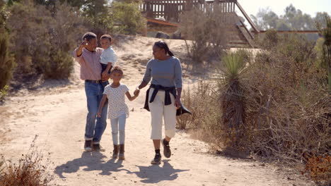 grandparents and grandchildren talk while walking