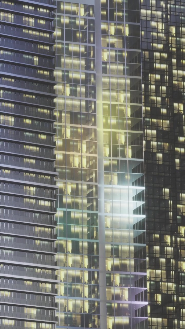 City buildings reflect lights at night with colorful patterns seen from below