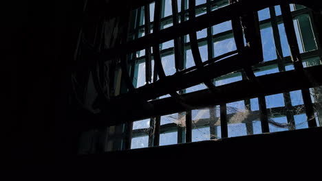 Alcatraz-Federal-Prison-USA,-Cobweb-on-Metal-Bars-and-Window,-Inside-View