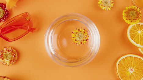 orange floral arrangement with sunglasses and citrus slices