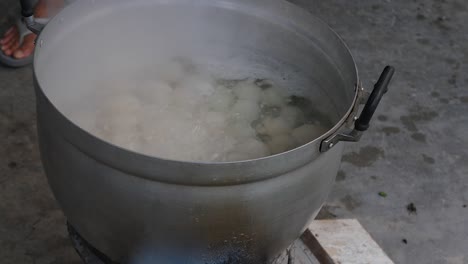 duck eggs boiling in big metal pot