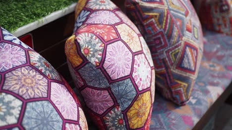 colorful patterned pillows on a bench