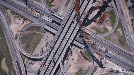 construction resumes along an overpass with steel beams and concrete pillars