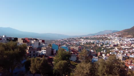 Stunning-panoramic-view-of-Chefchaouen,-the-blue-religious-city-as-a-popular-travel-destination-in-the-background-in-Morocco