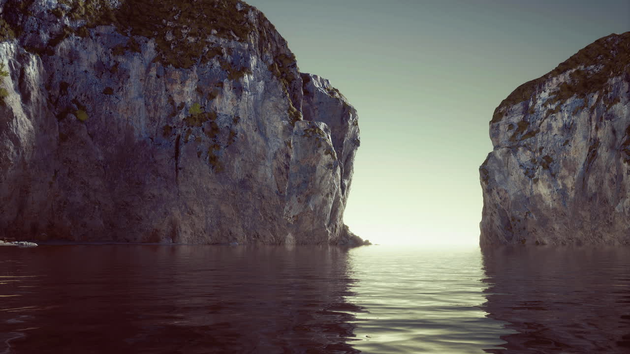 Majestic cliffs reflecting in tranquil water at dawn near the coast