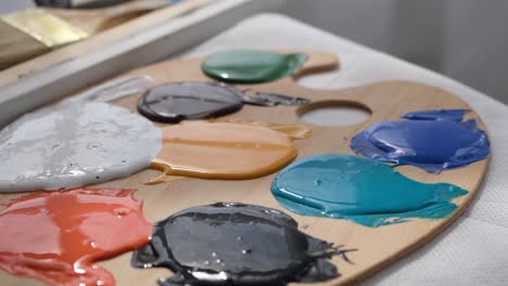 colorful wooden artist palettes in motion a collection of wooden artist palettes floating in a light blue background each palette has colorful paint spots in various arrangements creating a playful and artistic atmosphere